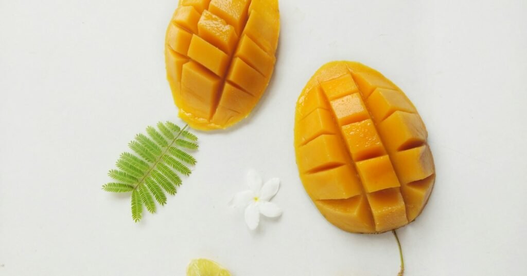 Ripe mangoes with green leaves in a tropical growing setting